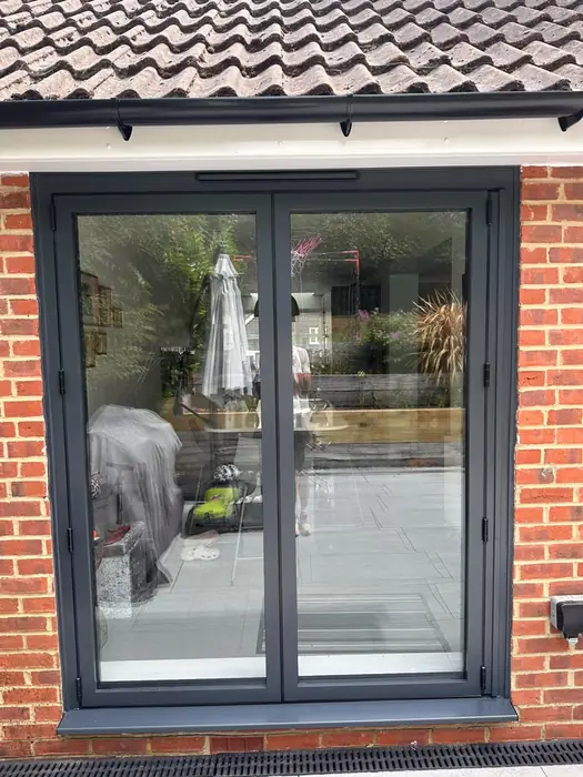 Grey aluminium sliding patio doors installed by Team Frames