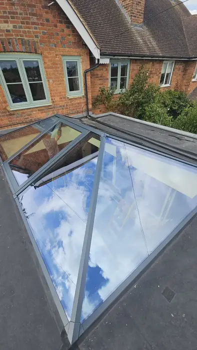 Grey aluminium roof lantern installed on a flat roof by Team Frames