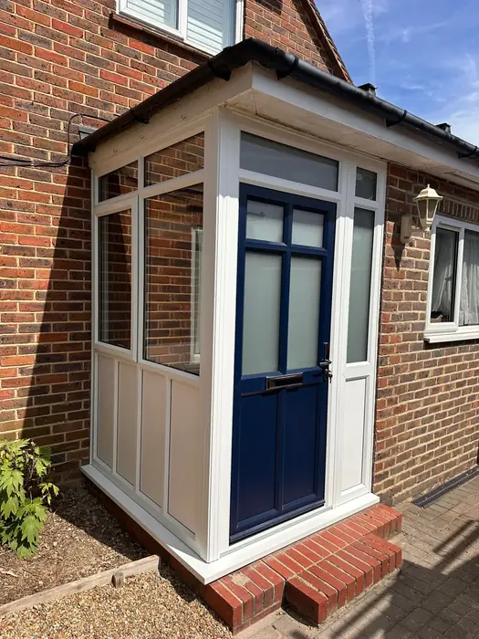 White uPVC porch with entrance door built by Team Frames in Surrey