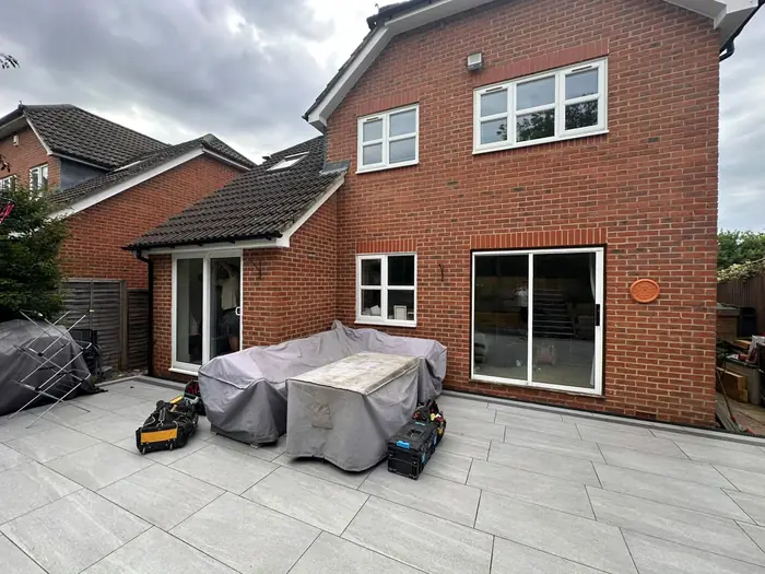 Grey aluminium bi-fold doors opening onto a porcelain patio