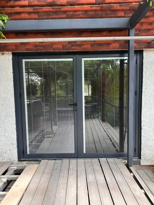 Anthracite grey French patio doors with integral blinds installed by Team Frames