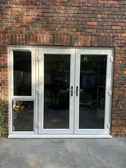 White uPVC French doors opening onto a patio, fitted by Team Frames