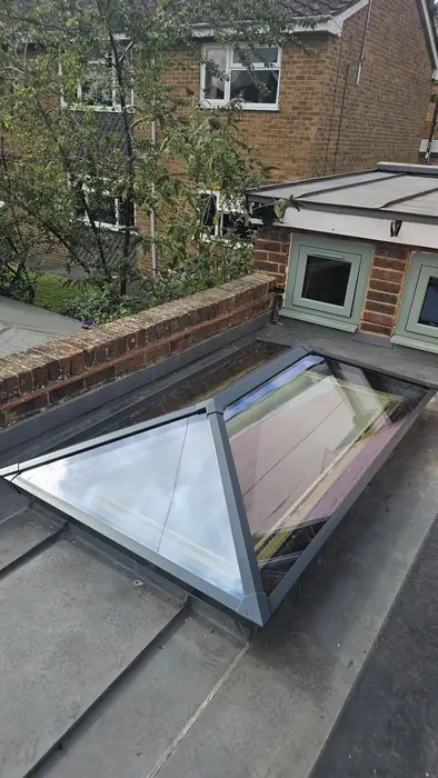 Grey aluminium roof lantern installed on a flat roof by Team Frames