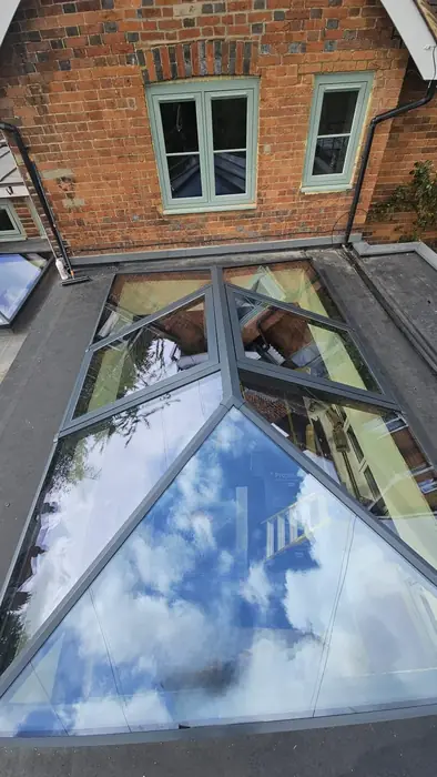 Grey aluminium roof lantern installed on a flat roof by Team Frames