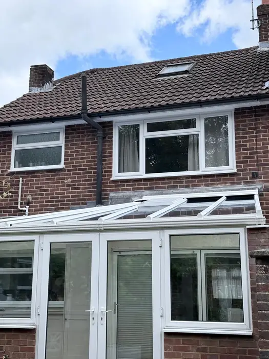 White uPVC conservatory to the rear of a house, built by Team Frames