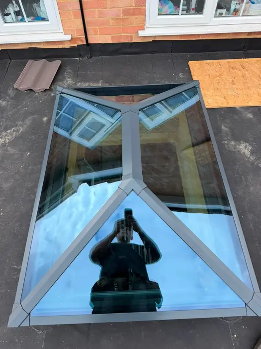 Grey aluminium roof lantern installed on a flat roof by Team Frames