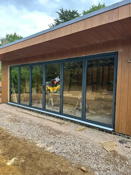 Dark aluminium bi-fold doors installed by Team Frames in Surrey